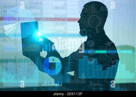 Double exposure of graphs and silhouette of young businessman with laptop. Data science concept Stock Photo