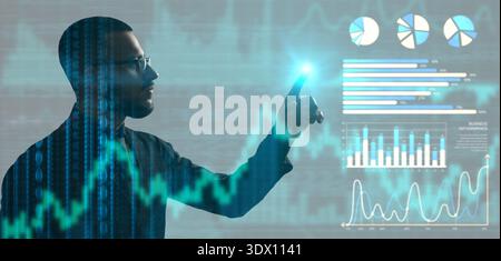 Silhouette of young businessman touching virtual screen. Data science concept Stock Photo
