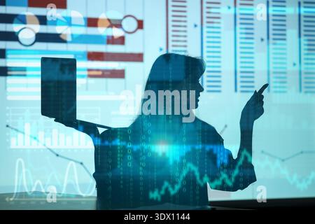 Silhouette of young businesswoman with laptop pointing at charts. Data science concept Stock Photo