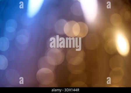 Soft out-of-focus light spheres in blue and warm amber tones creating a dreamy abstract texture Stock Photo