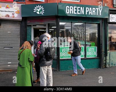 Green Party campaign HQ in Gorton, Manchester, with volunteers collecting leaflets and “Vote Green” posters displayed in the windows. Stock Photo