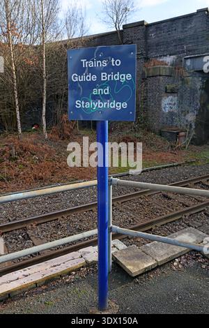 Blue platform sign for trains to Guide Bridge and Stalybridge at Denton railway station, Greater Manchester, England. Stock Photo
