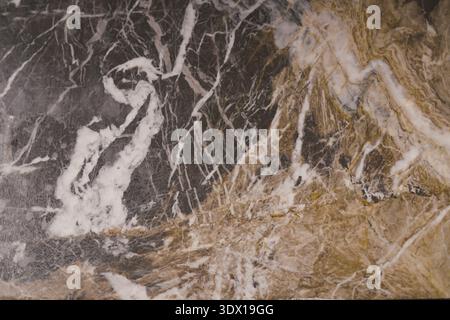 Marble surface with white and gold patterns in a close view Stock Photo