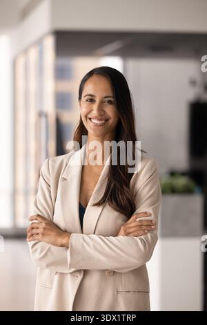 Professional New Zealander businesswoman in elegant jacket standing in office Stock Photo