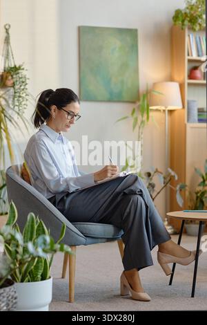 Caucasian Middle Aged Woman Taking Notes during Psychological Counseling Session Stock Photo