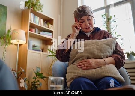 Middle Aged Woman Sitting Alone Reflecting on Emotional Wellbeing Stock Photo