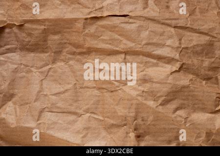 Crumpled paper bread packaging with greasy stains for the topics of food packaging, paper contamination, oil stains, and kraft paper texture Stock Photo