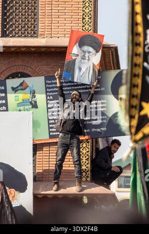 A Kashmiri Shia Muslim man shouts religious slogans during a procession ...