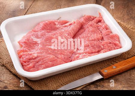 Raw veal escalopes in a tray Stock Photo