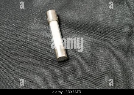 A small transparent fuse on a leather background Stock Photo