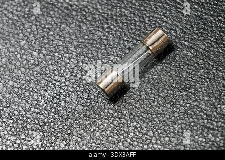 A small transparent fuse on a leather background Stock Photo