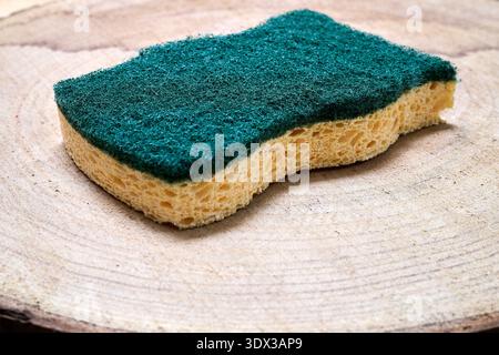 green micro-fiber absorbent  sponge on a wooden background Stock Photo