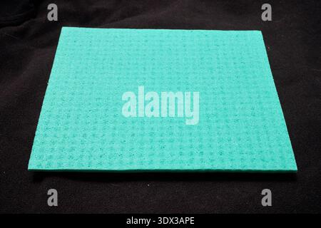 green micro-fiber sponge on a black background Stock Photo
