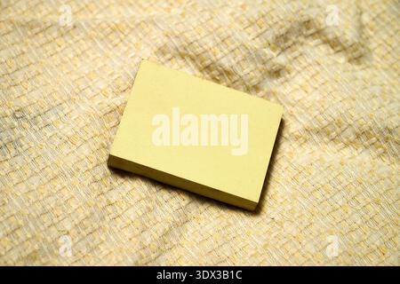 A small pad of yellow sticky notes on yellow background Stock Photo