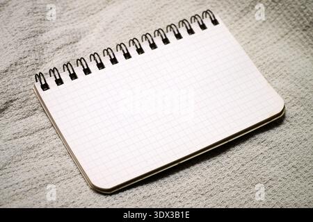 A small spiral notebook with grid lines Stock Photo