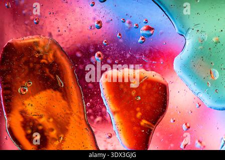 Unique abstract background featuring earthy brown and soft pink liquid tones with floating oil spheres. Stock Photo