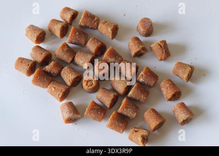 Cane jaggery cubes made from sugarcane juice. Traditional unrefined natural sweetener widely used in Indian cooking, baking and healthy recipes Stock Photo