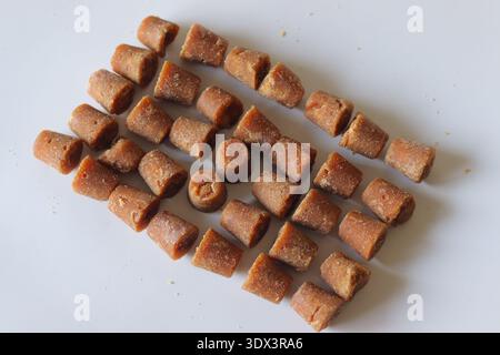 Cane jaggery cubes made from sugarcane juice. Traditional unrefined natural sweetener widely used in Indian cooking, baking and healthy recipes Stock Photo