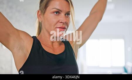 Woman focusing on an energetic upper body workout Stock Photo