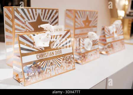 Penang, Malaysia - November 15, 2025: Four Christian Dior gift boxes featuring elegant designs and ribbons are arranged on a display table in a boutiq Stock Photo