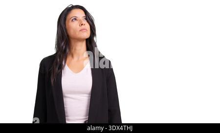 Woman in blazer thinking looking up searching Stock Photo