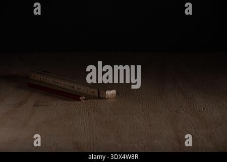 Carpentry measuring and marking tools placed on wooden floor before renovation work. Concept of DIY home improvement, construction planning and floori Stock Photo