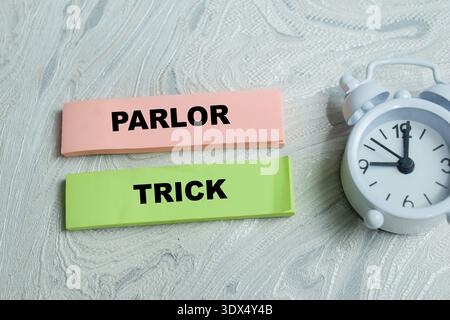 Concept of parlor trick write on sticky notes isolated on Wooden Table. Representing deception, simple illusion and clever manipulation Stock Photo