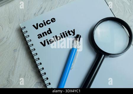 Concept of voice and visibility write on book isolated on Wooden Table. For social empowerment Stock Photo