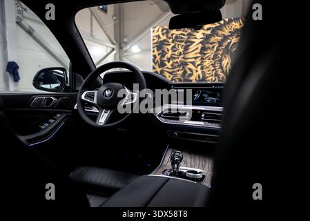 BMW X7 cockpit with leather wheel, crystal shifter, and welcome screen Stock Photo