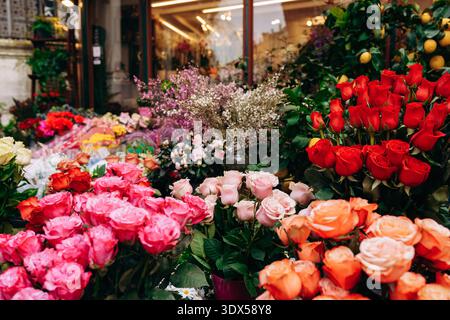 Colorful flower market shows many roses and other flowers in different colors Stock Photo