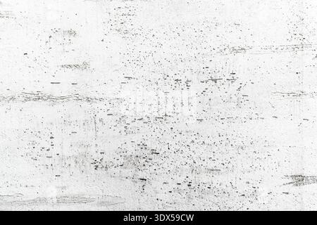 Abstract white concrete wall with black speckles and scratches texture and background Stock Photo