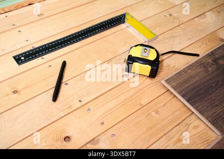 Tools and Materials Arranged on Wooden Surface for DIY Project Preparation and Measurement Tasks Stock Photo