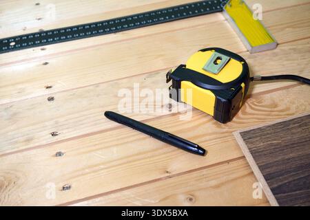 Measuring Tools on Wooden Surface: Tape Measure, Pencil, and Ruler for Precision Work Stock Photo
