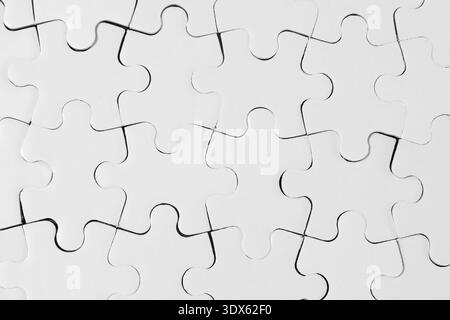 Top-Down View of Connected White Jigsaw Puzzle Pieces Stock Photo