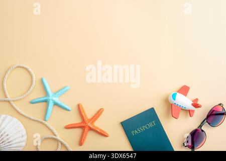 Toy airplane, passport, starfish and sunglasses on yellow background. Travel concept. Top view, flat lay, copy space. Stock Photo
