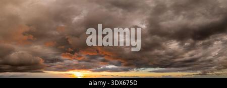 Beautiful sunset sky scenery. Bright colorful orange and yellow clouds on horizon Stock Photo