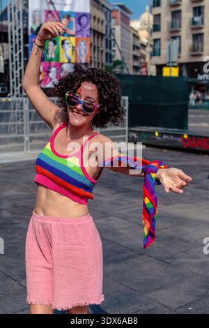 Young woman celebrating pride with rainbow apparel and confident pose Stock Photo