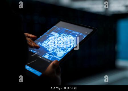 Close up of data center admin using AI assistant to install equipment used for hosting digital services. Server hub worker repairing mainframes managing file transfers using artificial intelligence Stock Photo