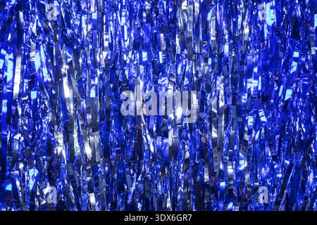 A vivid abstract background featuring a dazzling array of blue glitter creating a mesmerizing bokeh effect. The glowing texture adds depth and a sense Stock Photo