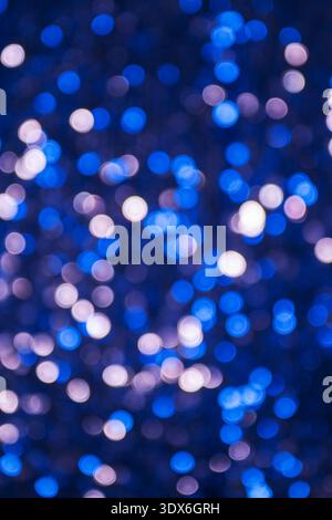 Abstract glowing background featuring blue and white bokeh lights, creating a dreamy and shimmering texture. Perfect for festive, celebratory, or magi Stock Photo