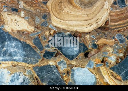 High-resolution image showcasing a calcareous conglomerate with intricate natural patterns and textures, featuring various shades of blue, gray, and b Stock Photo