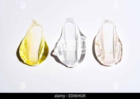 Three different cosmetic textures, showcasing a variety of gels and creams in vibrant colors, highlighted against a clean white background for an appe Stock Photo
