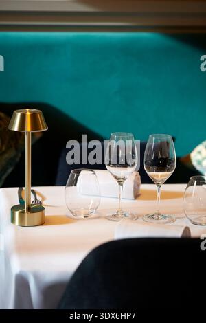 A sophisticated dining setup featuring wine glasses and elegant decor in a gourmet restaurant setting. Perfect for depicting a refined dining atmosphe Stock Photo