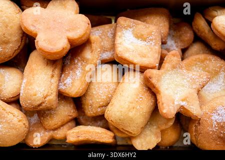 A delightful assortment of homemade cookies sprinkled with sugar, showcasing various shapes like stars and flowers, perfect for satisfying sweet cravi Stock Photo