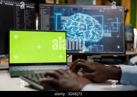 Green screen laptop used by data scientist in artificial intelligence startup office building scalable solutions for businesses. IT worker uses deep learning tech on mockup notebook in office, closeup Stock Photo