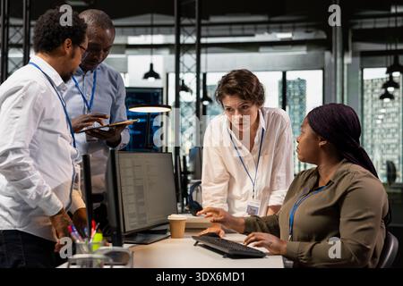 AI startup engineering team developing software in office, analyzing system performance metrics during QA testing. Coworkers discussing about tech roadmap during project briefing session Stock Photo