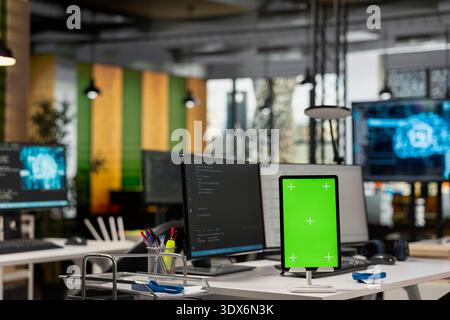 Isolated screen tablet on startup office desk showing deep learning programming languages written by developers. Mockup device in artificial intelligence company workspace used for code testing Stock Photo