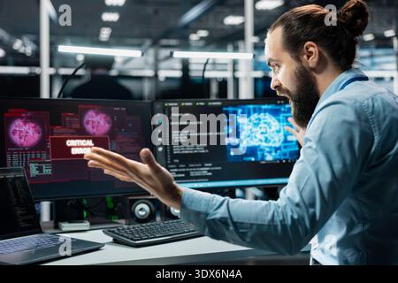Angry data center engineer raging, struggling to fix malfunctions while using AI tools. Annoyed server hub worker upset by critical error while using artificial intelligence to optimize system health Stock Photo