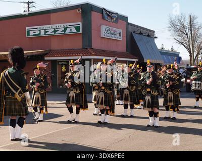 Port Jervis, New York St. Patrick's Day parade. With traditional bagpipers and Asian-American marchers along Front St. Numerous Fire Companies as well. Stock Photo