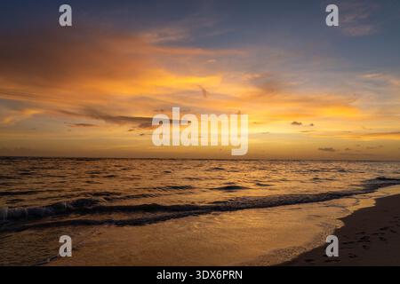 Sunrise with Orange Sky Over the Caribbean Sea in Punta Can Dominican Republic Stock Photo
